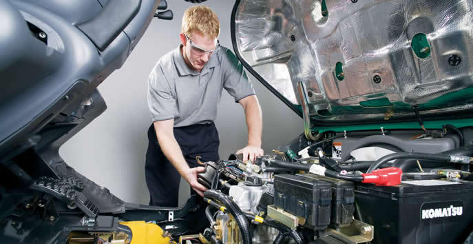 Auto Technician Examining Automotive Elements