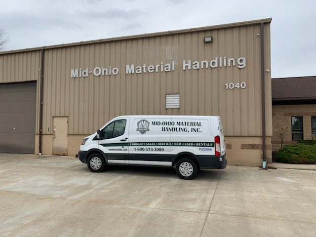 Mid Ohio Material Handling vehicle parked in front of storefront.